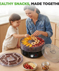Mother and child using Professional Electric Countertop Food Dehydrator With Five Stackable Trays for making jerky and dried fruit.
