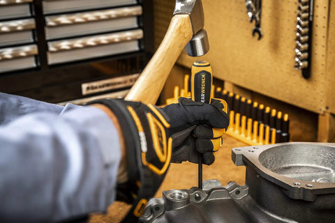 Using the Bolt Biter 2 Piece Impact Extraction Screwdriver Set for stubborn bolts and fasteners in an automotive workspace.