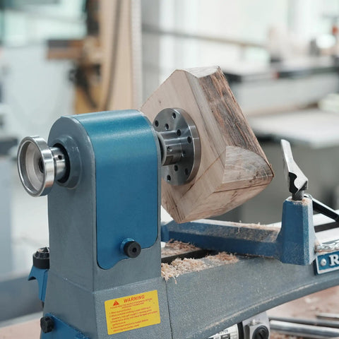 No Nonsense Heavy Duty 4 Inch Steel Wood Lathe Faceplate With 1x8TPI Spindle holding a rough wooden blank on a lathe.