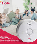 Dual Hazard Smoke And Carbon Monoxide Detector With Voice Warning Hardwired Setup And Ten Year Sealed Lithium Battery Backup Interconnectable Network Built Tough For Zero Drama Family Safety White in living room with family.