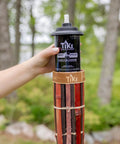 Person holding easy pour canister on 60 Inch Bamboo Torches 4-Pack With Easy Pour 12 Oz Canisters, Long-Lasting Fiberglass Wicks And Snuffers, Outdoor Patio Garden Lawn Decor In Walnut And Pecan Finish