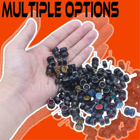 Hand holding 1/64 Scale Diecast Car Wheels And Tires Set Mixed Random Realistic Wheel Rims With Printed Detail For Customizing Cars Variety Pack For 1/64 Models Great For Collectors And Hobbyists on orange background.