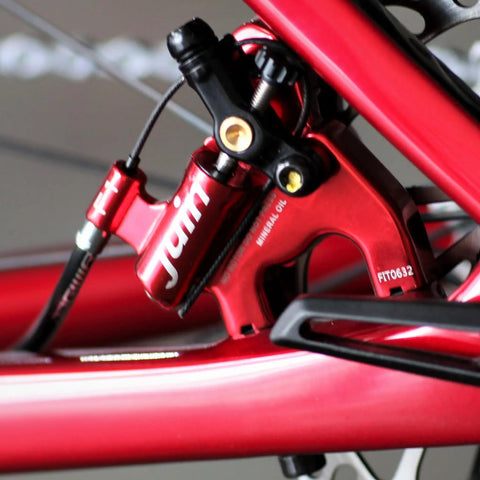 F1 Hybrid Hydraulic Disc Brake Set With Flat Mount Front And Rear Calipers 160mm Rotors Included For Road And Gravel Bikes close-up of red caliper.