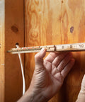 Person using a Five Eighths Inch Eight Foot Red End Wood Rule With Six Inch Slide Rule Extension For Inside Measurements on wood