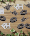 Top Shelf Black Twist Lock Clasps For Leather Bags And Diaries Heavy Duty Zinc Alloy Oval Turn Buttons set on wooden background.