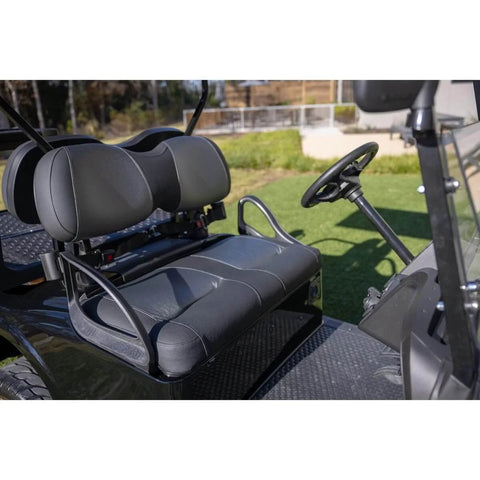 Golf cart with black leather seats parked on grass