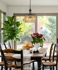 Straight Up Gorgeous Farmhouse Chandelier Featuring Three Woven Rattan Shades illuminating a dining table with natural light.