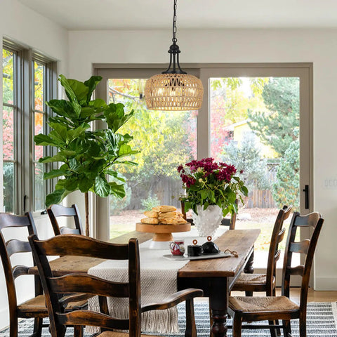 Straight Up Gorgeous Farmhouse Chandelier Featuring Three Woven Rattan Shades illuminating a dining table with natural light.