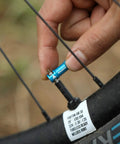 Oil Slick Alloy Valve Cap With Built In Valve Core Remover No Tools Needed For Presta Valves being used on bike wheel