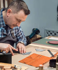 Dunzoom laser material kit: craftsman cuts orange leather shapes on a cutting mat.