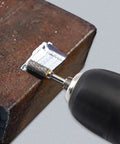 Hardcore Tungsten Carbide Rotary Burr in action on metal, 6mm cutting bit, showcasing precise detail and smooth finishes