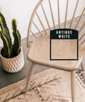 Premium Antique White Oil Based Wood Stain Spray Hits Intricate Corners And Gap Lines Super Fast Without Any Drama While Leaving A Slick Velvet Finish on a wooden chair.