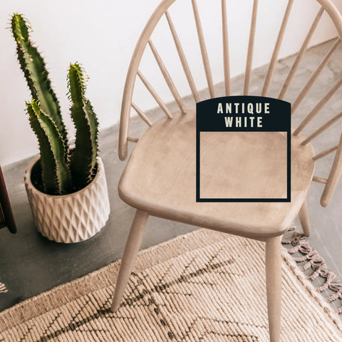 Premium Antique White Oil Based Wood Stain Spray Hits Intricate Corners And Gap Lines Super Fast Without Any Drama While Leaving A Slick Velvet Finish on a wooden chair.