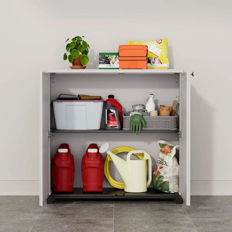 Indoor Outdoor Plastic Storage Cabinet With One Shelf 34 X 15 X 34 Inches White Weather Resistant UV Protected. Two red containers on bottom shelf, assorted items on top shelf.