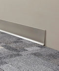 Heavy Duty Vinyl Cove Wall Base Molding Trim In Aircraft Carrier Finish with flexible strength, installed between floor and wall.