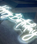 Close-up of Birthday Neon Sign LED Wall Backdrop 23.6x9.45 Inches Custom Party Neon Light glowing on dark surface.
