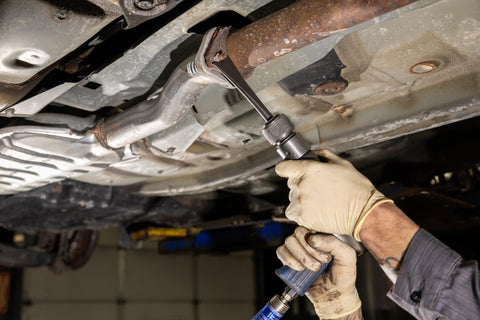 Using 20-Piece Pneumatic Tool Set With Black Oxide Finish, Pro-Grade Precision Fit Tools on car undercarriage