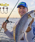 Angler holding fish caught with Inshore Jig Head For Soft Plastics With Red Eye And Red Hook 1/4 Ounce 5 Count Pack