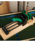 Rock Solid 6 Inch Quick Action Bench Vise With 300 Pound Clamping Power Easy Clamp Mount and green handle in workshop setting.