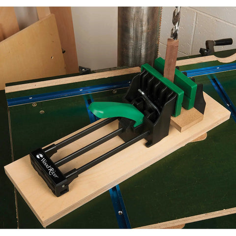 Rock Solid 6 Inch Quick Action Bench Vise With 300 Pound Clamping Power Easy Clamp Mount and green handle in workshop setting.