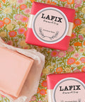 Slick Round Printable Labels 1 2/3 Inch Matte White 600 Count on LAFIX Homemade Soap packaging, decorative background.