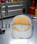 Boss Level Stainless Steel Mesh Face Shield And Rugged Welding Grinder Mask With No Sweat Ventilation For Tough Job Sites And Heavy Duty Workshop Grind on workbench with tools.