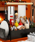 Grill Caddy With Dual Paper Towel Holders For Outdoor BBQs, loaded with condiments and utensils, black steel, by fireplace.