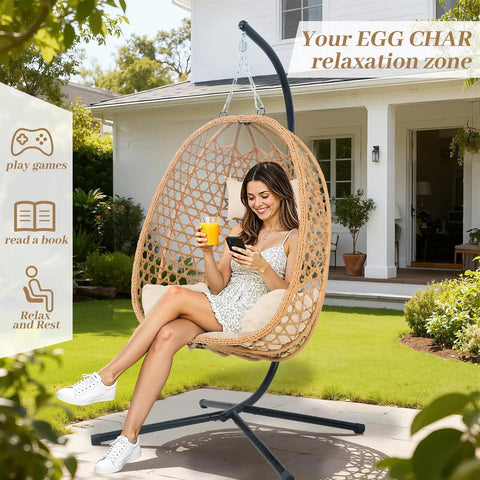 Woman sitting in Hanging Egg Chair With Cushions And Stand For Patio Garden Or Balcony Chill Outdoor Swing Chair Cozy Rattan Lounge Seat For Indoor Or Outdoor Use 350 Lbs Capacity Yellow