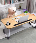 Foldable Laptop Desk For Bed Or Couch with drawer, used as a table for computer and coffee, ideal for sofa or floor use.