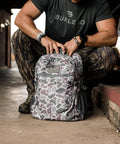 Man adjusting Deer Camo Backpack for School and Everyday Outdoor Adventures 25L Capacity with Ample Storage Durable