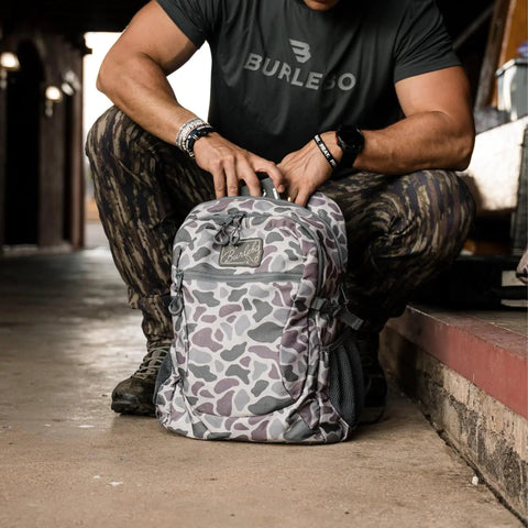 Man adjusting Deer Camo Backpack for School and Everyday Outdoor Adventures 25L Capacity with Ample Storage Durable