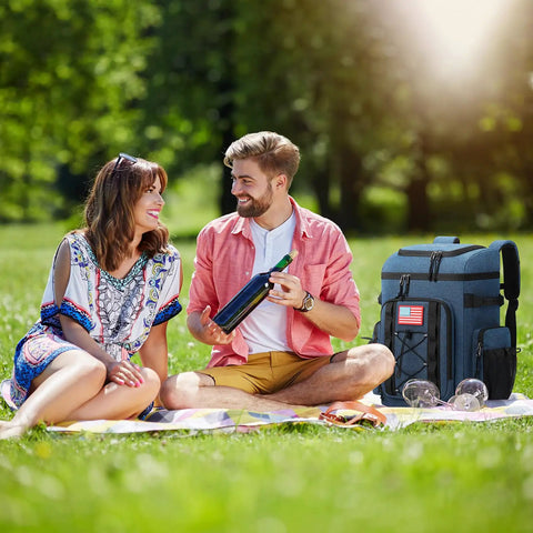 Couple enjoying picnic with Soft Lightweight Leakproof Backpack Cooler For 35 Cans, Insulated Bag, on grass