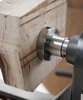 Rugged As A Nail Heavy Duty Steel Wood Lathe Faceplate Three Inches Diameter mounted on wood block for precise shaping.