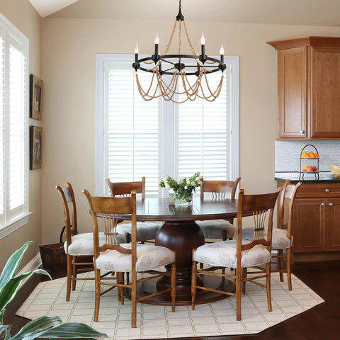 Natural Boho 28 Inch Chandelier With Wooden Bead Tassels And Rust Iron Black Wagon Wheel Frame in dining room setting.