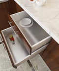Open kitchen drawers lined with silver stainless steel contact paper, showing peel and stick aluminum foil application