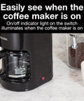 10-Cup Coffee Maker With Auto Pause And Serve on counter, visible carafe, and red on/off indicator light.