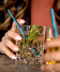 Jumbo Cocktail Straws Black With Blue Stripe 5.75 Inches Wrapped 6000 Count Compostable Marine Biodegradable Non Toxic Made In USA 6 Pack Eco Friendly Barware For Parties And Backyard Hangouts in cocktail glass