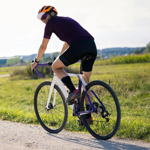 Cyclist on road bike equipped with Two Pack 26 Inch Beefed Up Heavy Duty Bike Inner Tubes With FV48mm Presta Valve Compatible tire sizes.