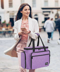 Woman carrying Portable Sewing Machine Case with Wheels and Shoulder Strap, Universal Rolling Trolley Tote in Purple, outdoors