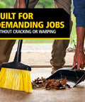 Person using Heavy Duty Dust Pan 12.25 Inch for Home and Professional Cleanup, collecting leaves with a broom on a patio
