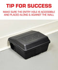 Rodent Station Trap Box With Four Bait Securing Rods And Security Key placed against wall for indoor outdoor use.