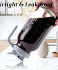 32 Oz Mason Jar Cold Brew Pitcher With Strainer And Wide Mouth Glass Spout Lids For Fridge Iced Coffee Tea Lemonade Sun Tea 1 Quart Brew Maker Dishwasher Safe No Mess shown tilted with coffee inside