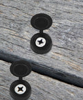 100 Piece Hinged Plastic Screw Cover Caps Set With Shutter Fold Snap Covers, Flip Top Caps on wooden surface