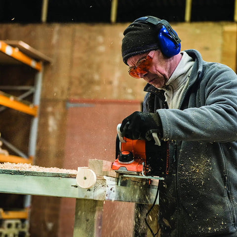 Man using Beast 750W 2 in 1 Electric Wood Planer And Sander With 17 Position Depth Control in a woodworking shop