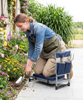 Woman gardening with Foldable Garden Kneeler And Seat With Two In One Design For Comfortable Weeding And Raised Bed Work Detachable EVA Foam Pad 350 Lbs Heavy Duty Metal Frame Tool Pouch Portable Stool For Seniors Blue