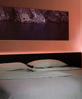 Bedroom with Smart LED Light Strip With Full Color Spectrum And White 1800 Lumens Adaptive Lighting above headboard.