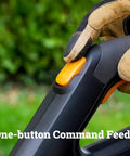 Gloved hand pressing button on Cordless String Trimmer and Lawn Edger for 12 Inch Cutting Path, 20V Weed Eater with Instant Line Feed.