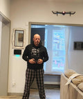 Man indoors flying a 4K Camera Drone For Kids And Adults, Foldable Silent Quadcopter with 120 Degree Wide Lens, 60fps HD Video And Photos