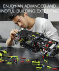 Man assembling Lamborghini Sian FKP 37 1:8 Scale Tech Model Car Kit for Grownups with 3,696 pieces on a table.