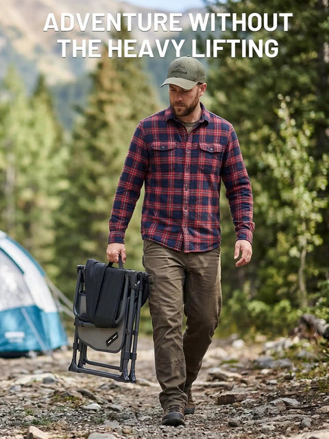 Man carrying Heavy Duty Camping Chair With Compact Fold Built In Side Table And Pocket in outdoor setting